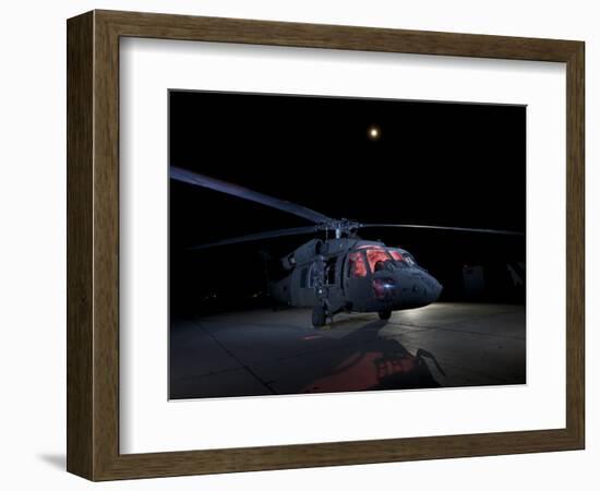 A UH-60 Black Hawk Helicopter Parked on the Flight Line under a Full Moon-null-Framed Photographic Print