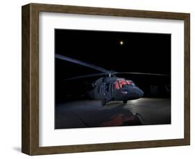 A UH-60 Black Hawk Helicopter Parked on the Flight Line under a Full Moon-null-Framed Photographic Print