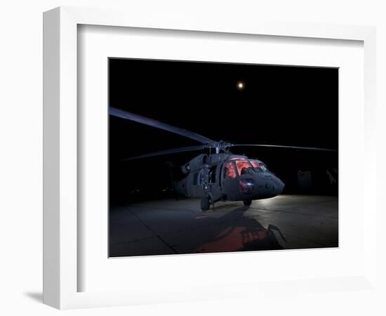 A UH-60 Black Hawk Helicopter Parked on the Flight Line under a Full Moon-null-Framed Photographic Print