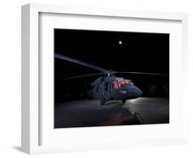 A UH-60 Black Hawk Helicopter Parked on the Flight Line under a Full Moon-null-Framed Photographic Print