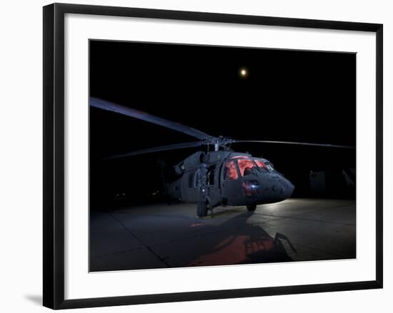 A UH-60 Black Hawk Helicopter Parked on the Flight Line under a Full Moon-null-Framed Photographic Print