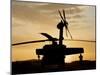 A UH-60L Black Hawk Helicopter Silhouetted by the Setting Sun-null-Mounted Premium Photographic Print