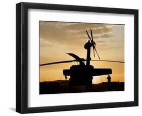A UH-60L Black Hawk Helicopter Silhouetted by the Setting Sun-null-Framed Photographic Print