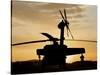 A UH-60L Black Hawk Helicopter Silhouetted by the Setting Sun-null-Stretched Canvas