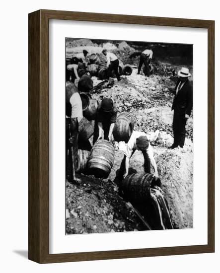 A Us Federal Agent Oversees the Destruction of Beer Kegs During the American Prohibition Era…-American Photographer-Framed Photographic Print