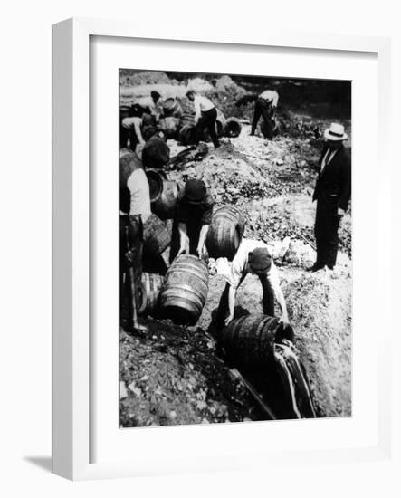 A Us Federal Agent Oversees the Destruction of Beer Kegs During the American Prohibition Era…-American Photographer-Framed Photographic Print