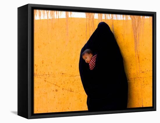 A Veiled Woman Carries Her Child Through the Streets of Erfoud-null-Framed Stretched Canvas