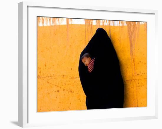 A Veiled Woman Carries Her Child Through the Streets of Erfoud-null-Framed Photographic Print