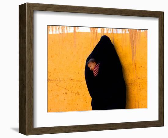 A Veiled Woman Carries Her Child Through the Streets of Erfoud-null-Framed Photographic Print
