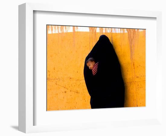 A Veiled Woman Carries Her Child Through the Streets of Erfoud-null-Framed Photographic Print