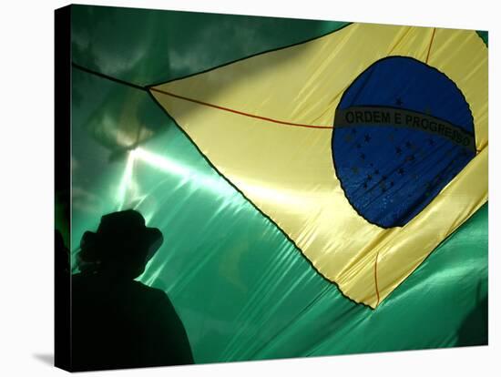 A Vendor Walks Behind a Big Brazilian Flag-null-Stretched Canvas