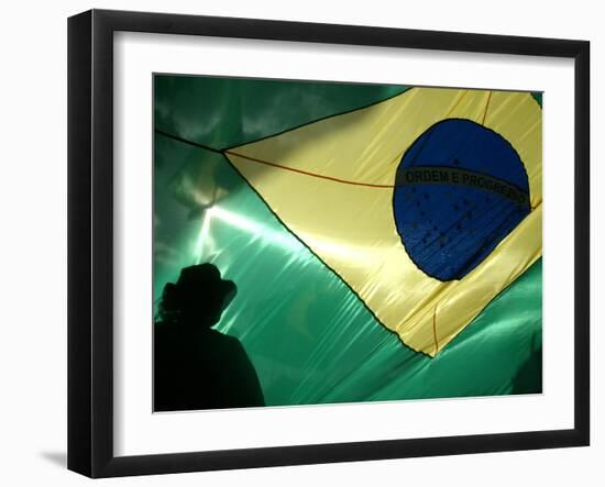 A Vendor Walks Behind a Big Brazilian Flag-null-Framed Premium Photographic Print