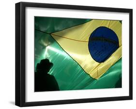 A Vendor Walks Behind a Big Brazilian Flag-null-Framed Premium Photographic Print