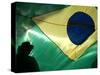 A Vendor Walks Behind a Big Brazilian Flag-null-Stretched Canvas