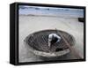 A Vietnamese Fisherman Does Repairs on His Basket Boat on a Beach-null-Framed Stretched Canvas