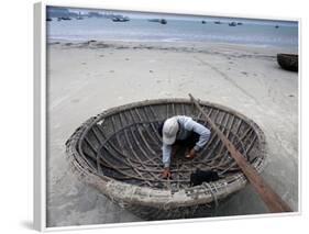 A Vietnamese Fisherman Does Repairs on His Basket Boat on a Beach-null-Framed Photographic Print