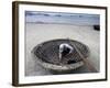 A Vietnamese Fisherman Does Repairs on His Basket Boat on a Beach-null-Framed Photographic Print