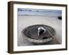 A Vietnamese Fisherman Does Repairs on His Basket Boat on a Beach-null-Framed Photographic Print