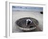 A Vietnamese Fisherman Does Repairs on His Basket Boat on a Beach-null-Framed Photographic Print