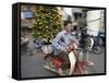 A Vietnamese Vendor Races Down a Street on a Motorbike Carrying a Kumquat Tree for Sale-null-Framed Stretched Canvas