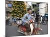 A Vietnamese Vendor Races Down a Street on a Motorbike Carrying a Kumquat Tree for Sale-null-Mounted Photographic Print