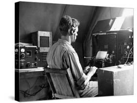 A View of a Soldier Using Communications Equipment During US Army Maneuvers-John Phillips-Stretched Canvas