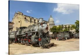 A Vintage Steam Train in a Restoration Yard with Dome of Former Parliament Building in Background-Sean Cooper-Stretched Canvas