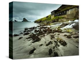 A Waterfall Cascading over the Black Sand Beach of Bour into the Sorvagsfjorour, Vagar Island, Faro-Kimberley Coole-Stretched Canvas