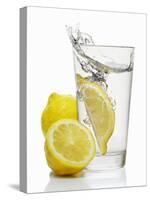 A Wedge of Lemon Falling into a Glass of Water-Kröger & Gross-Stretched Canvas