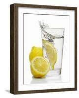 A Wedge of Lemon Falling into a Glass of Water-Kröger & Gross-Framed Photographic Print