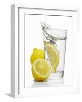 A Wedge of Lemon Falling into a Glass of Water-Kröger & Gross-Framed Photographic Print