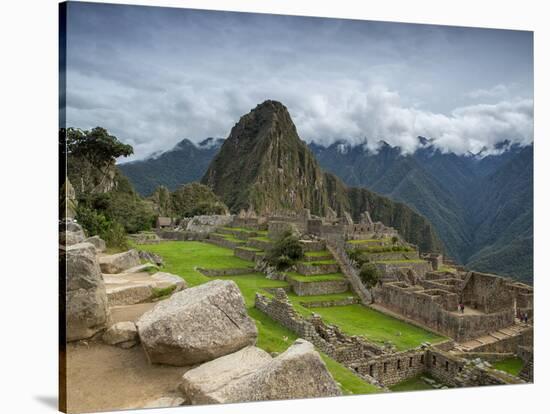 A wide angle photo of Macchu Pichu at sunrise with dramatic clouds in the distance.-Alex Saberi-Stretched Canvas