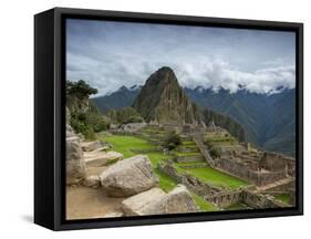 A wide angle photo of Macchu Pichu at sunrise with dramatic clouds in the distance.-Alex Saberi-Framed Stretched Canvas