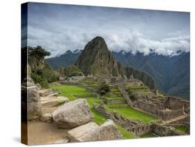 A wide angle photo of Macchu Pichu at sunrise with dramatic clouds in the distance.-Alex Saberi-Stretched Canvas