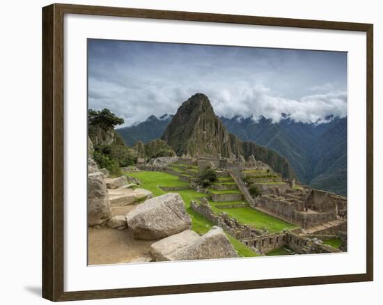 A wide angle photo of Macchu Pichu at sunrise with dramatic clouds in the distance.-Alex Saberi-Framed Photographic Print