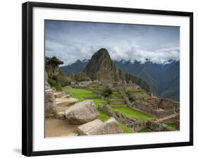 A wide angle photo of Macchu Pichu at sunrise with dramatic clouds in the distance.-Alex Saberi-Framed Photographic Print