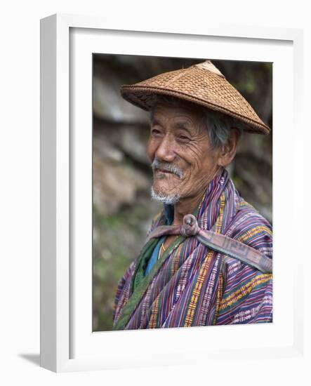 A Wizened Old Farmer Near Mongar Wears the Traditional Knee-Length National Robe Called Gho and a B-Nigel Pavitt-Framed Photographic Print