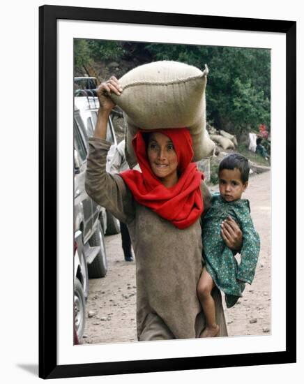 A Woman Carries Relief Supplies at Jula Village, Near Uri, India-null-Framed Photographic Print