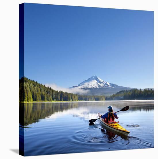 A Woman in a Sea Kayak Paddles on Trillium Lake, Oregon, USA-Gary Luhm-Stretched Canvas