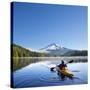 A Woman in a Sea Kayak Paddles on Trillium Lake, Oregon, USA-Gary Luhm-Stretched Canvas