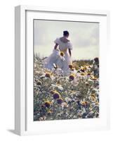 A Woman in a White Victorian Dress, Walking Among Camomile Flowers on a Meadow on a Sunny Day-Malgorzata Maj-Framed Photographic Print