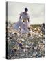 A Woman in a White Victorian Dress, Walking Among Camomile Flowers on a Meadow on a Sunny Day-Malgorzata Maj-Stretched Canvas