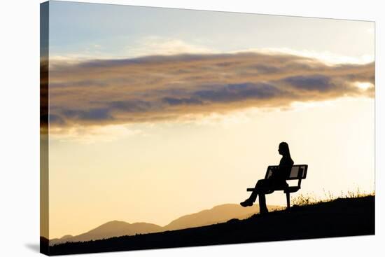 A Woman in Silhouette Sits on a Bench Along the Shelf Road Trail in Ojai California-Bennett Barthelemy-Stretched Canvas