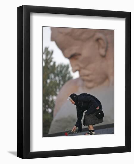 A Woman Lays Flowers on the Unknown Soldier Monument Near the Brest Fortress-null-Framed Premium Photographic Print