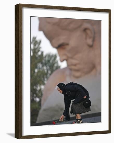 A Woman Lays Flowers on the Unknown Soldier Monument Near the Brest Fortress-null-Framed Photographic Print