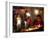 A Woman Lights Earthen Lamps as Children Ignite Firecrackers in New Delhi-Manish Swarup-Framed Photographic Print