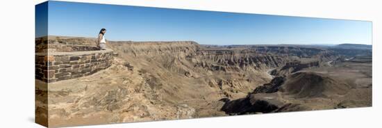 A Woman Looks into the Fish River Canyon in Southern Namibia, Africa-Alex Treadway-Stretched Canvas