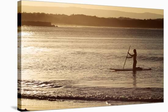 A Woman on a Stand-Up Paddleboard Heads Towards Main Beach, Noosa, at Sunset-William Gray-Stretched Canvas