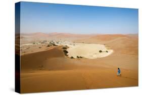 A Woman Runs Down from the Summit of Sossusvlei Sand Dune, Namibia, Africa-Alex Treadway-Stretched Canvas