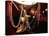 A Woman's High Heeled Shoe Hangs with Some Mardi Gras Beads-null-Stretched Canvas